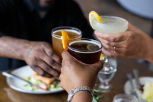 Three people clinking glasses